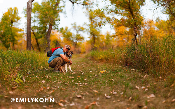 Man hiking with his dog in the fall