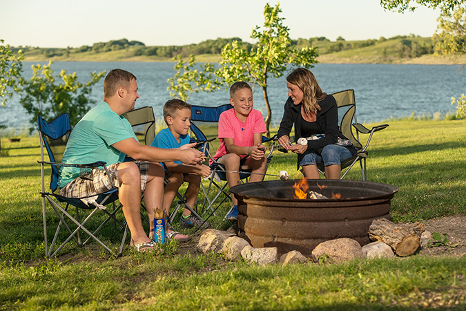 Family camping by a fire