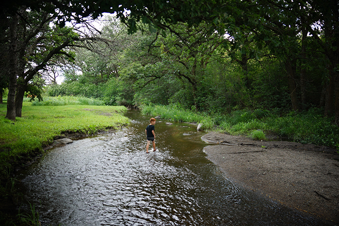 Boy walking through Clausen Springs Recreation Area