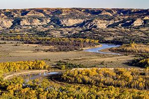 Vibrant fall colors offset the Little Missouri River in the north unit of Theodore Roosevelt National Park