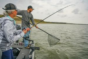 A couple is ready to pull a fish out of the water on the upper Missouri River