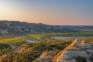Vibrant fall colors offset the Little Missouri River in the north unit of Theodore Roosevelt National Park