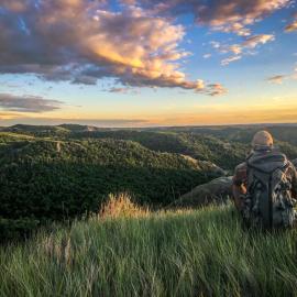 Great Outdoors Adventure, photo with hiker overlooking North Dakota badlands by Sierrah Fischer