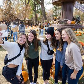 Girls taking selfies at a pumpkin patch