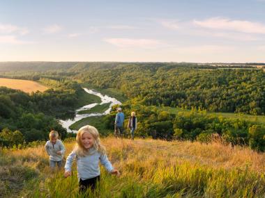 Family runs in the wide open space overlooking Pembina Gorge