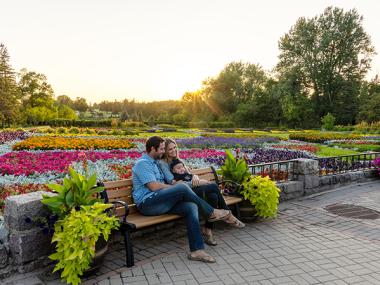 Family sitting on a bench at the International Peace Garden