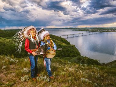 Photo with Native Americans standing on Crow Flies High with the Four Bears bridge in NewTown by Ben Gumeringer