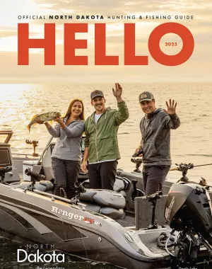 2025 Hunting & Fishing guide with three fishermen holding fish on cover