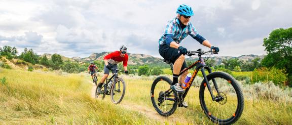 People Biking on a grass trail in North Dakota