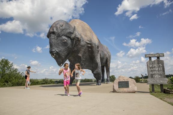 Kids having fun at the World's Largest Buffalo Monument in Jamestown