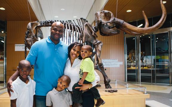 A family poses in front of the mastodon at the Heritage Center in Bismarck.