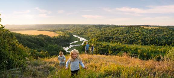 Family runs in the wide open space overlooking Pembina Gorge