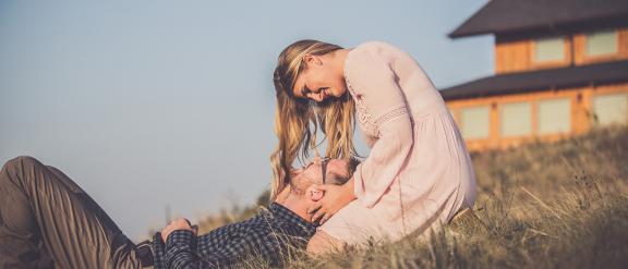 Couple lays in the grass outside the Coteau des Prairies lodge. Courtesy Phillip Breker
