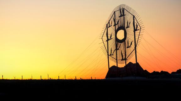 Geese In Flight sculpture at sunset