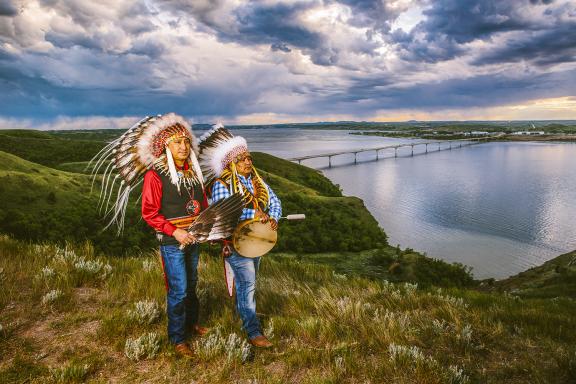 Photo with Native Americans standing on Crow Flies High with the Four Bears bridge in NewTown by Ben Gumeringer