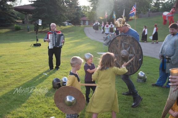 Children playing with adults in historical costumes