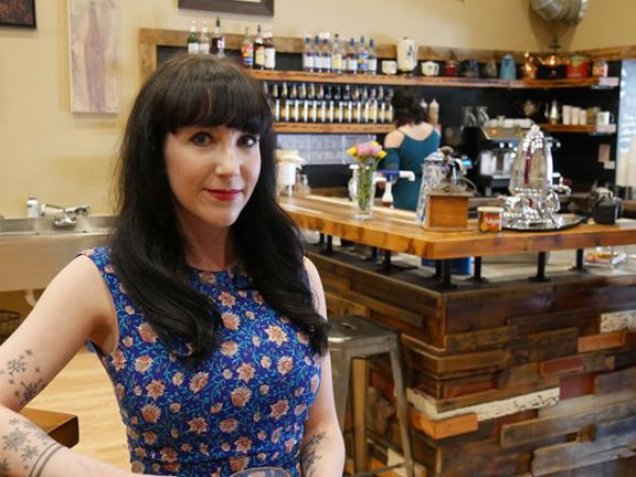 Lindsay Veeder standing in a cozy, well-lit coffee shop