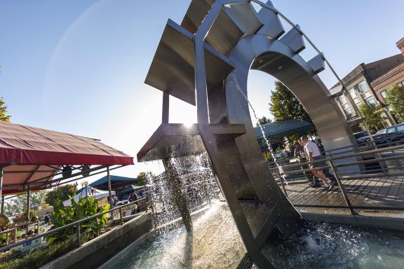 A large paddle wheel sculpture is featured in a public area