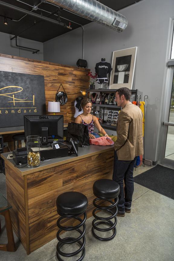 People shopping at a rustic downtown store counter