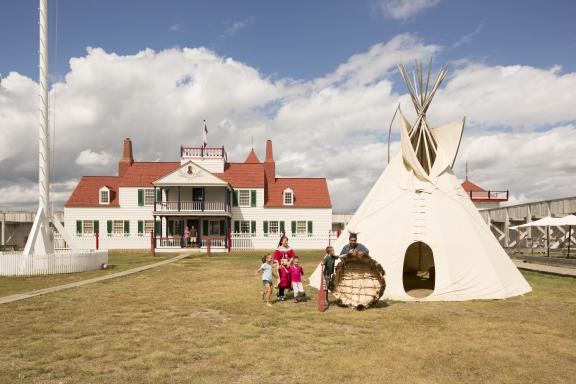 A scene at Fort Union Trading Post, showing a group of people gathered around
