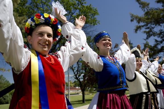  A close-up view of a cultural dance, focusing on the detailed costumes and intricate movements of the dancers
