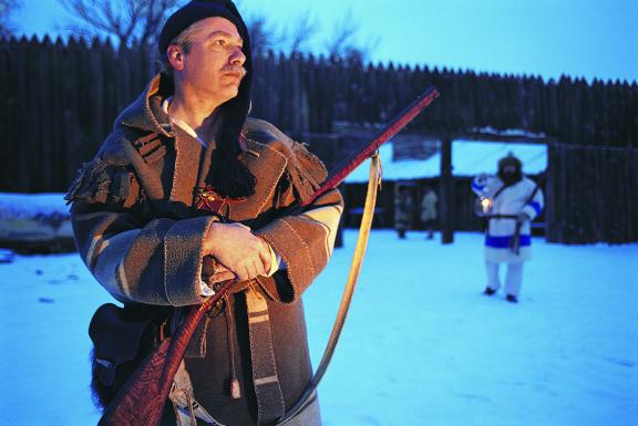 A man holding a gun at Fort Mandan