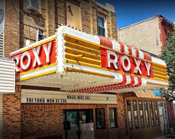 A vintage movie theater marquee with the name "ROXY"