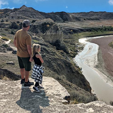 Dad and daughter overlooking wind canyon