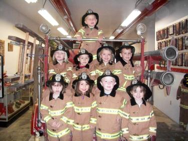 become a firefighter!  let your kids enjoy an experience at becoming a firefighter with our turnout gear available for kids to try on! photo