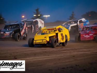 imca modifieds racing through the high banked corners of dacotah speedway photo