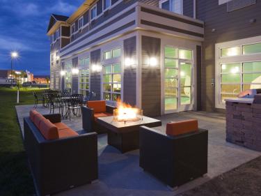 patio with fireplace and grill photo