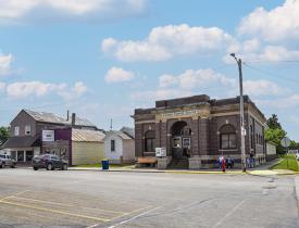 Photo of downtown Ellendale and kids running on the sidewalk