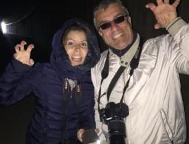 Man and woman posing for photo at night