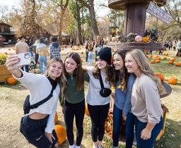 Girls taking selfies at a pumpkin patch