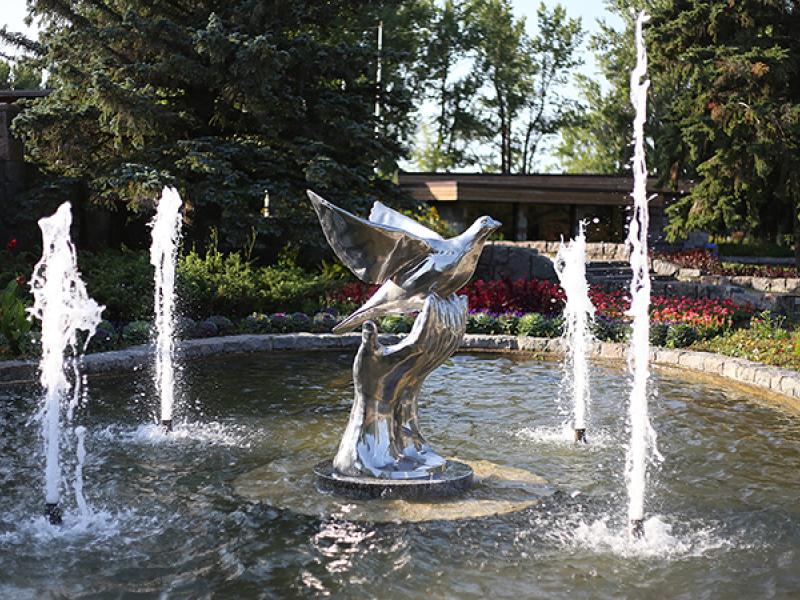 hand and dove peace statue